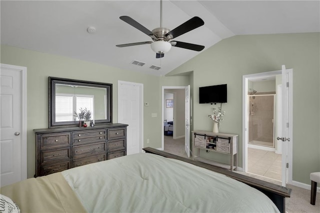 bedroom with visible vents, baseboards, vaulted ceiling, carpet flooring, and ensuite bath