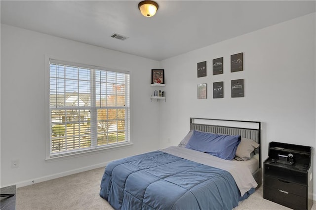 carpeted bedroom featuring visible vents and baseboards