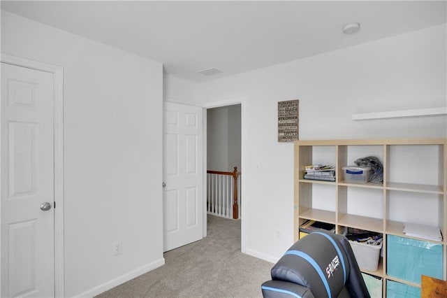 exercise area featuring baseboards and carpet floors