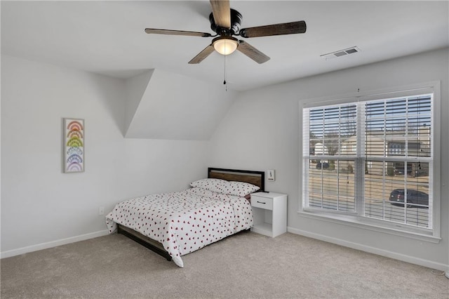 bedroom with a ceiling fan, baseboards, visible vents, carpet floors, and lofted ceiling