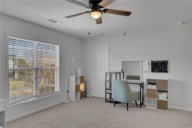 carpeted office space with a ceiling fan, baseboards, and visible vents