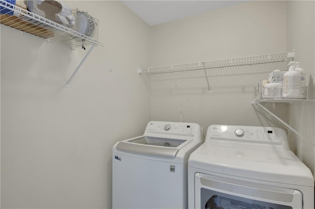 washroom featuring laundry area and washer and dryer