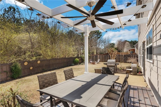 view of patio with area for grilling, a pergola, outdoor dining area, and a fenced backyard