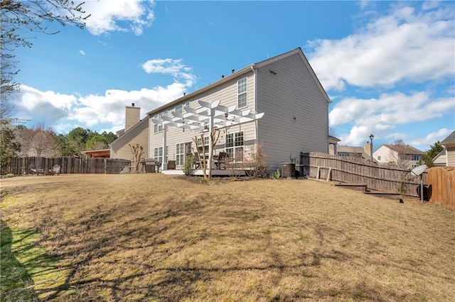 rear view of property featuring a pergola, a fenced backyard, a yard, central AC unit, and a chimney