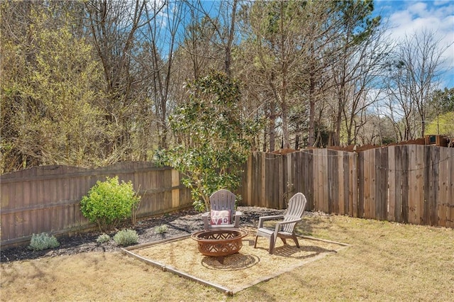 view of yard with a fire pit and a fenced backyard