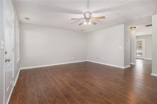 spare room with ceiling fan, a textured ceiling, and dark hardwood / wood-style floors