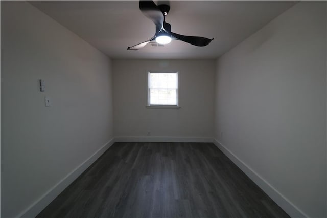 spare room featuring dark hardwood / wood-style floors and ceiling fan