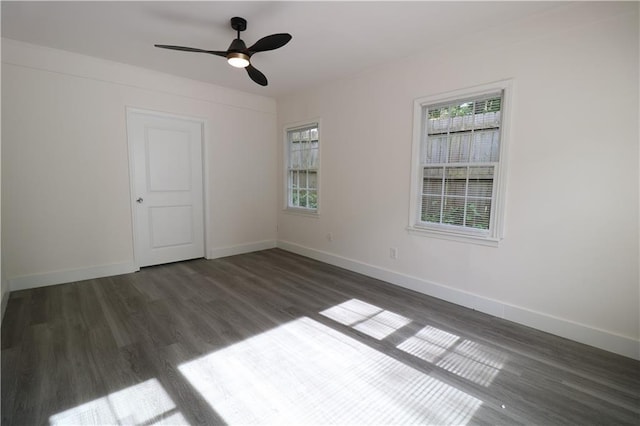 unfurnished room featuring dark hardwood / wood-style floors and ceiling fan