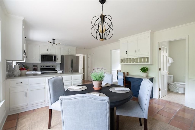 dining space featuring a chandelier and ornamental molding