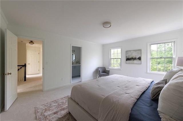 bedroom with baseboards and light carpet