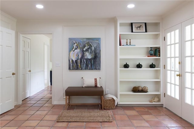 corridor with light tile patterned floors, recessed lighting, built in shelves, and ornamental molding