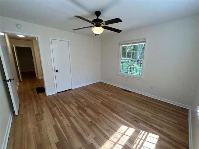 779 Casplan St SW, Atlanta, GA 30310 - unfurnished bedroom with baseboards, a ceiling fan, wood finished floors, and visible vents