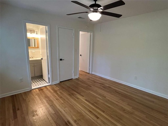 779 Casplan St SW, Atlanta, GA 30310 - unfurnished bedroom with wood finished floors, visible vents, a ceiling fan, ensuite bath, and baseboards