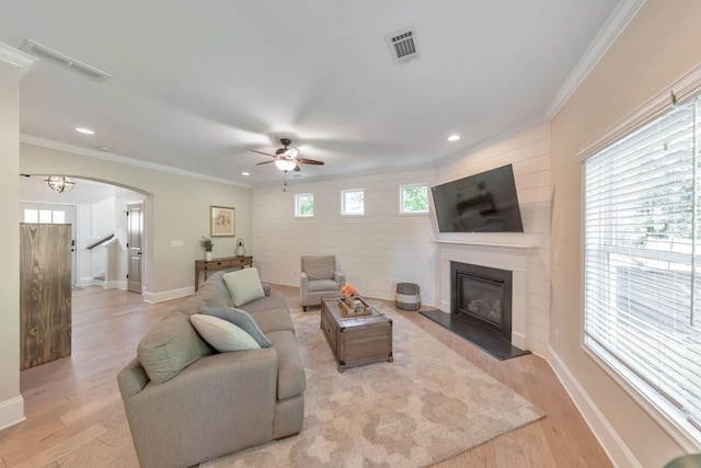 4230 Old Cherokee St, Acworth, GA 30101 - living area with arched walkways, ceiling fan, a glass covered fireplace, healthy amount of natural light, and crown molding