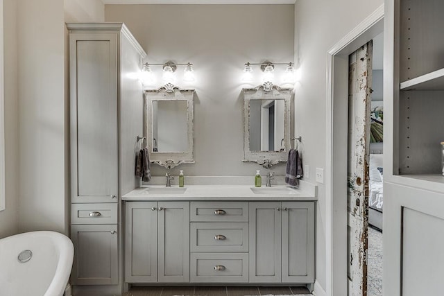 bathroom with a tub and vanity