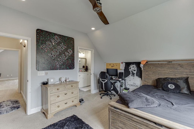 bedroom featuring ceiling fan, ensuite bath, lofted ceiling, and light colored carpet