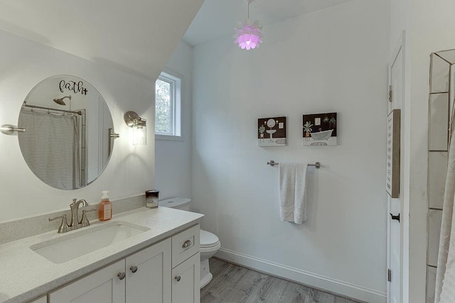 bathroom featuring toilet, vanity, hardwood / wood-style floors, and a shower with shower curtain