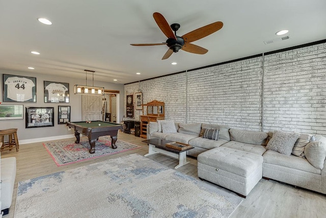 recreation room with pool table, hardwood / wood-style floors, brick wall, and ceiling fan