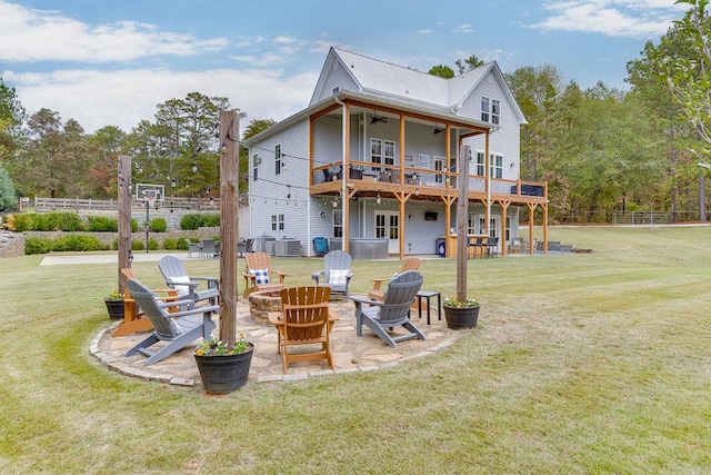 back of property featuring a patio, central AC, a yard, and a fire pit