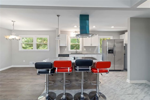 kitchen featuring a center island, white cabinetry, stainless steel fridge with ice dispenser, a kitchen breakfast bar, and island range hood