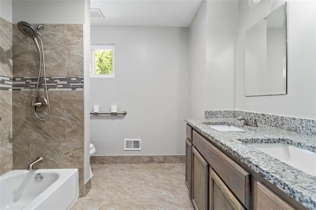 full bathroom featuring tiled shower / bath, vanity, and toilet