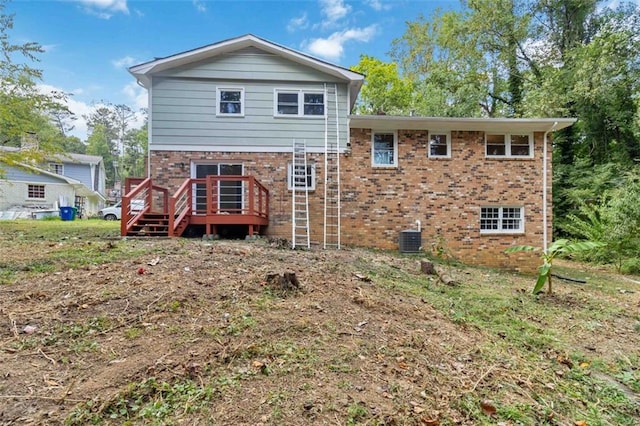 back of house with central AC unit and a deck