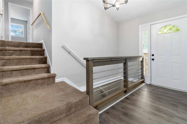 foyer with dark hardwood / wood-style flooring and a notable chandelier