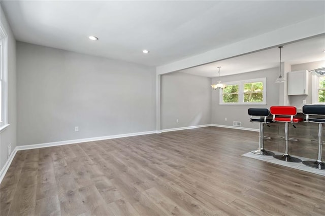 interior space featuring hardwood / wood-style floors and an inviting chandelier