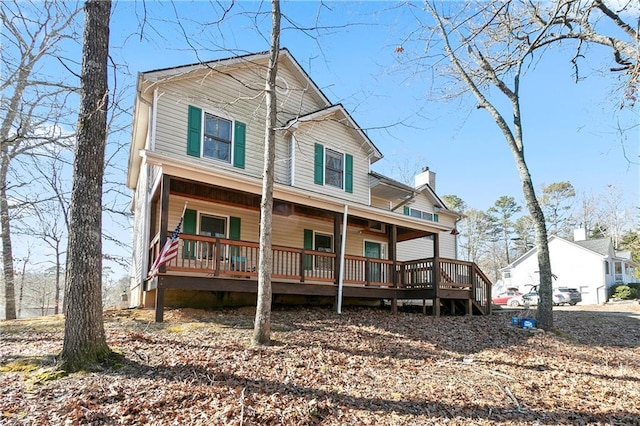 view of front of house featuring a porch and a chimney