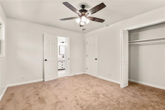 unfurnished bedroom with ceiling fan, a closet, and light carpet