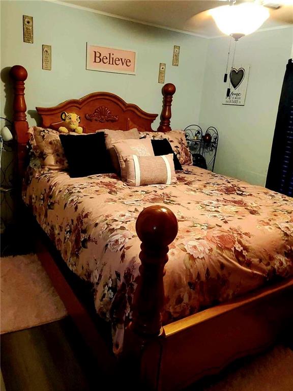 bedroom featuring hardwood / wood-style flooring and ceiling fan