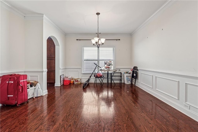 dining room with ornamental molding, arched walkways, and dark wood-style flooring