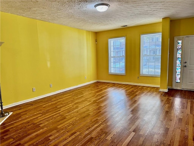 entrance foyer featuring wood-type flooring and a textured ceiling