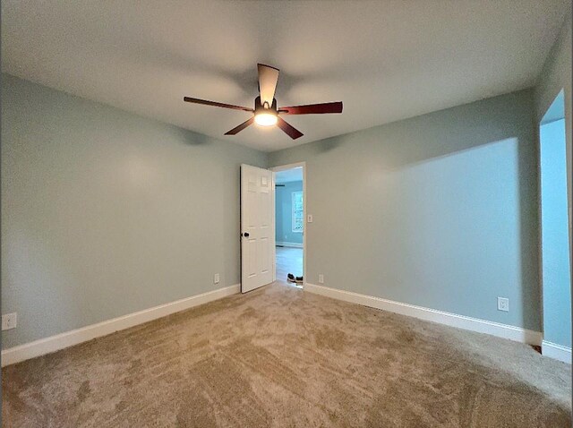 carpeted empty room with ceiling fan