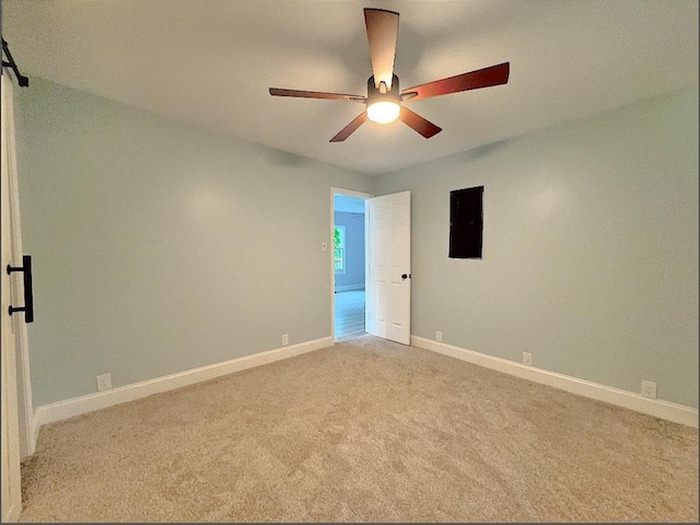 carpeted spare room with ceiling fan