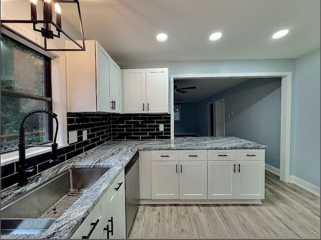 kitchen with white cabinets, tasteful backsplash, sink, ceiling fan, and stainless steel dishwasher