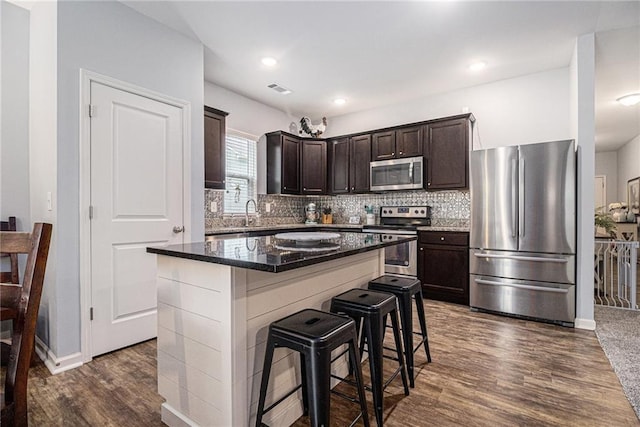 23 Stable Gate Dr, Cartersville, GA 30120 - kitchen with appliances with stainless steel finishes, dark brown cabinets, dark wood-style flooring, and decorative backsplash