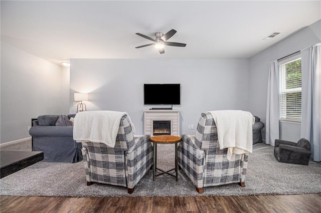 23 Stable Gate Dr, Cartersville, GA 30120 - living area with dark wood-type flooring, a ceiling fan, and a glass covered fireplace