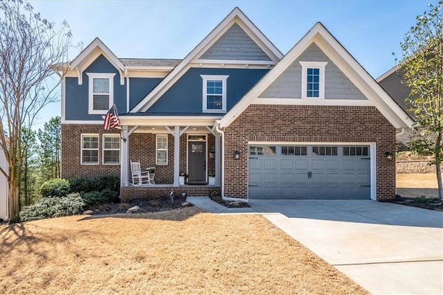 view of front of house with a front lawn, covered porch, concrete driveway, a garage, and brick siding