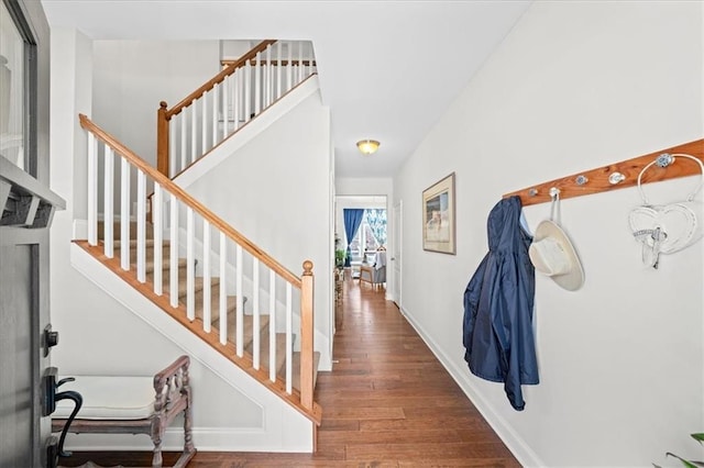 entrance foyer with stairs, baseboards, and wood finished floors