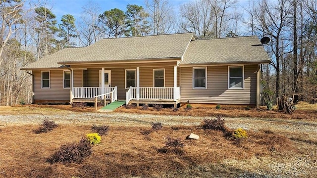 ranch-style house featuring a porch and a shingled roof