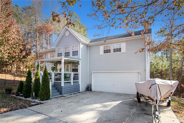 front of property with covered porch and a garage