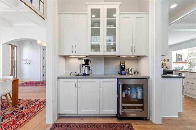 1601 Marlbrook Dr NE, Atlanta, GA 30307 - indoor bar featuring beverage cooler, light wood-type flooring, arched walkways, backsplash, and recessed lighting
