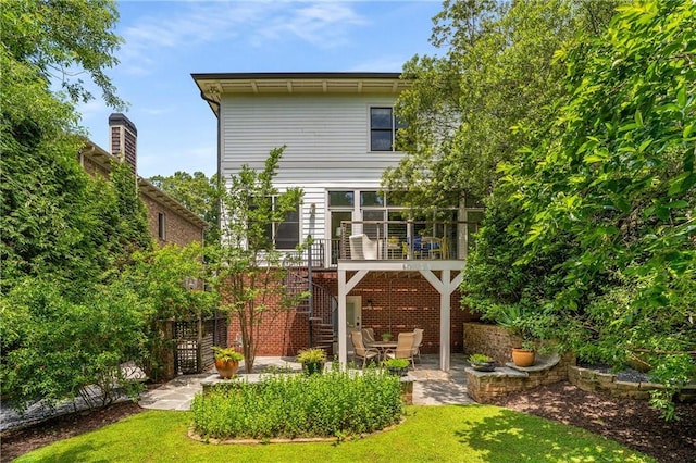 1601 Marlbrook Dr NE, Atlanta, GA 30307 - back of house with a patio area and a lawn