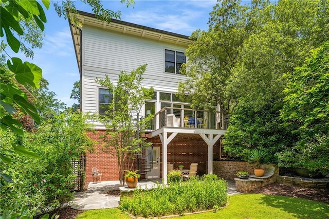 1601 Marlbrook Dr NE, Atlanta, GA 30307 - back of property featuring brick siding, a patio area, a balcony, and a lawn