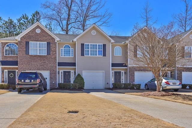 view of front of house featuring brick siding, a garage, driveway, and roof with shingles