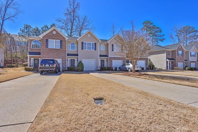 view of front facade with brick siding, a residential view, an attached garage, and driveway