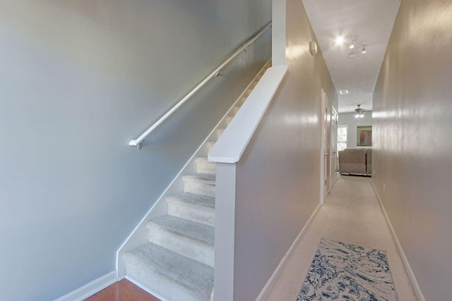 stairway featuring baseboards