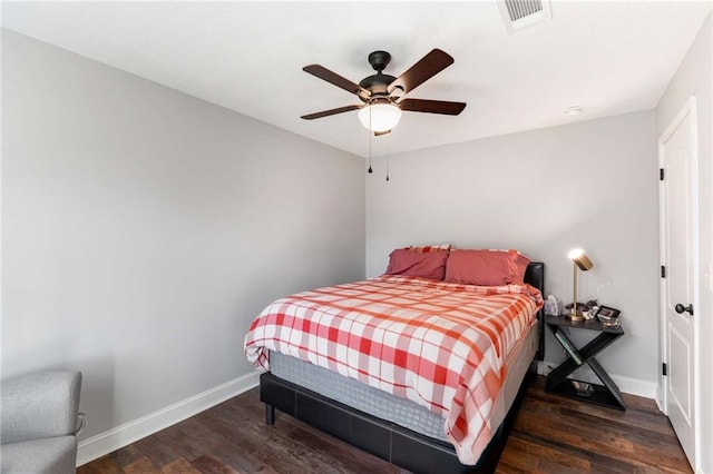 bedroom with visible vents, a ceiling fan, baseboards, and wood finished floors