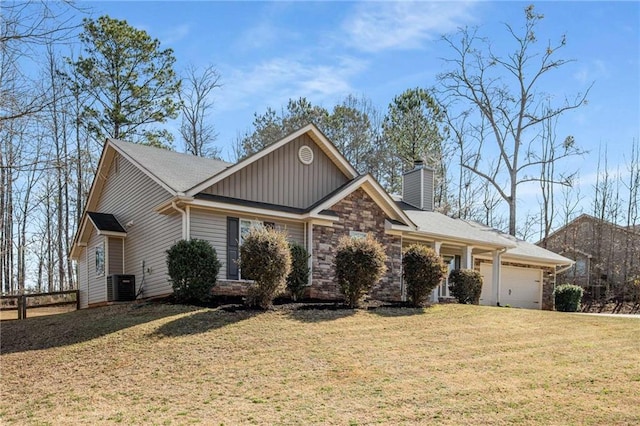 view of front of house featuring a front lawn, cooling unit, a chimney, a garage, and stone siding